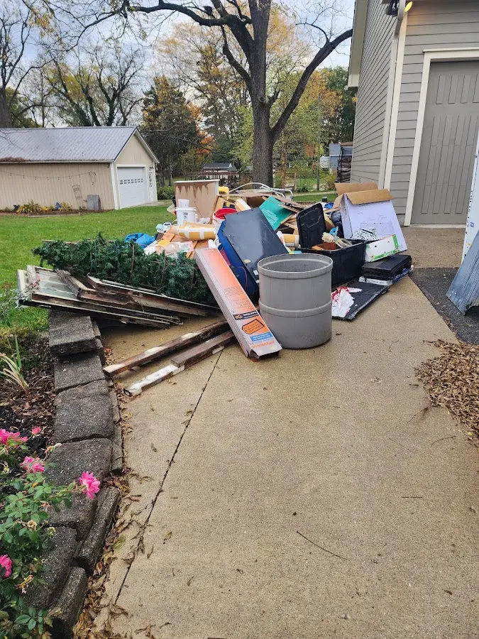 Dumpster being loaded with debris for Estate Cleanout Dumpster Rental in Winchendon